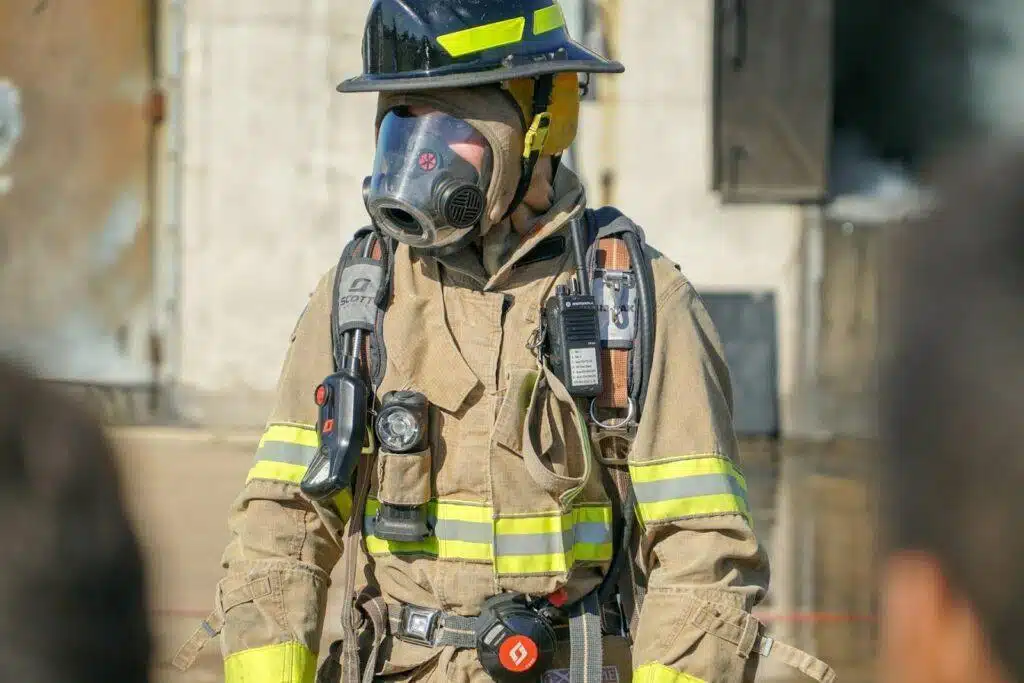 A firefighter dressed in full protective gear while out on the job