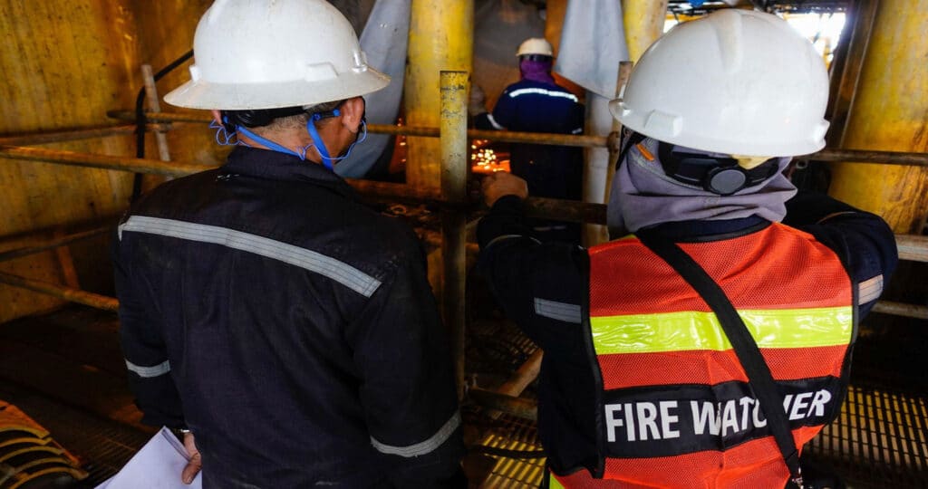 fire watch security guard observing welder
