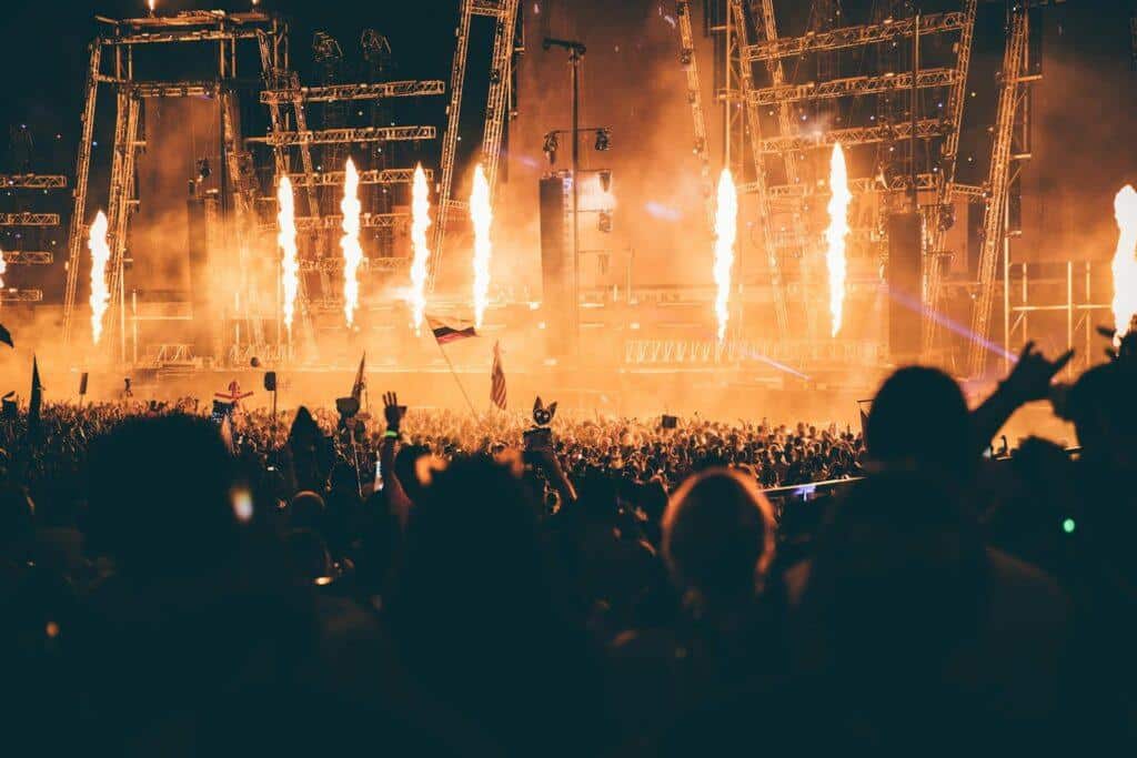 The pyrotechnics in full effect at a stadium gig with a large crowd